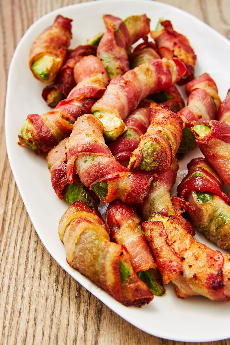 <p>You can't say no to anything wrapped in bacon. </p><p>Get the recipe from <a href="https://www.delish.com/cooking/recipe-ideas/recipes/a48261/bacon-avocado-fries-recipe/" rel="nofollow noopener" target="_blank" data-ylk="slk:Delish" class="link ">Delish</a>.</p>