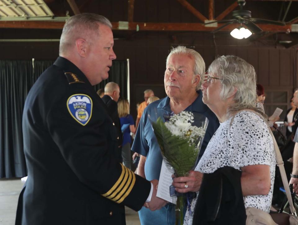Akron Police Chief Stephen L. Mylett, left, talks with Tom and Carol Reese after the Akron Police Memorial Day ceremony at the Fraternal Order of Police Akron Lodge 7 on Wednesday. CarolÕs brother Floyd A. Weatherholt Jr. was shot and killed by an armed burglar in 1960. 