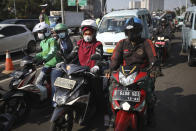 Motorists are seen wearing masks as a precaution against the coronavirus outbreak during rush hour traffic in Jakarta, Indonesia, Monday, Sept. 21, 2020. (AP Photo/Dita Alangkara)