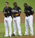 <p>Miami Marlins third baseman Martin Prado, from left, shortstop Adeiny Hechavarria and left fielder Marcell Ozuna stand during a pre-game ceremony honoring pitcher Jose Fernandez before a baseball game against the New York Mets, Monday, Sept. 26, 2016, in Miami. Fernandez died in a boating accident Sunday. (AP Photo/Lynne Sladky) </p>