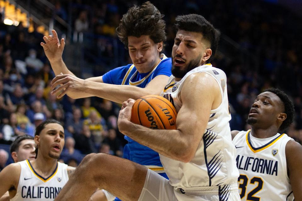 California Golden Bears forward Fardaws Aimaq (00) secures a rebound over UCLA Bruins forward Berke Buyuktuncel (9) during the second half at Haas Pavilion Feb. 10, 2024, in Berkeley, California.