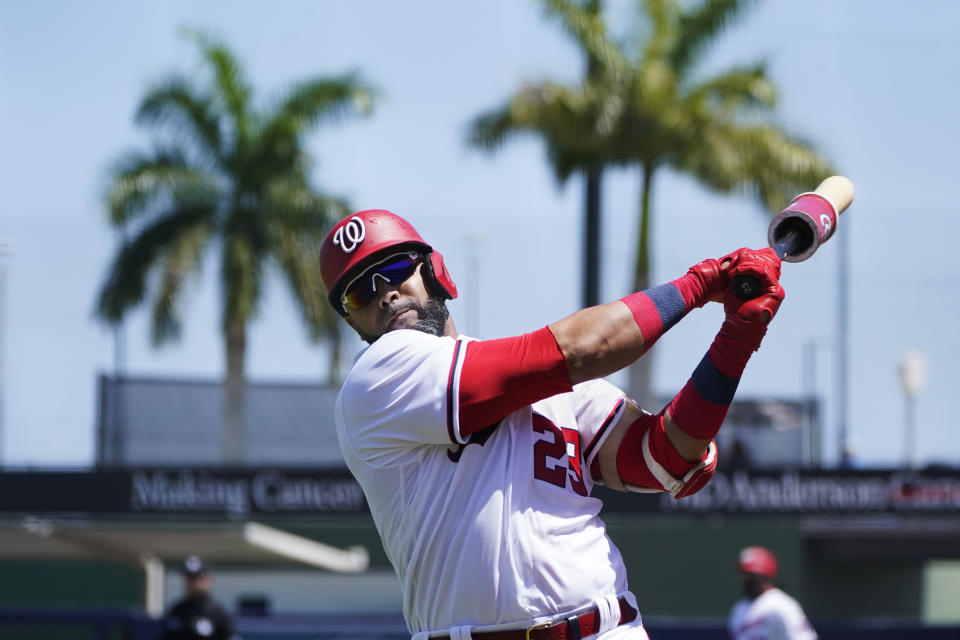 Washington Nationals' Nelson Cruz (23) warms up in the on-deck circle in the first inning of a spring training baseball game against the Miami Marlins, Monday, March 28, 2022, in West Palm Beach, Fla. (AP Photo/Sue Ogrocki)