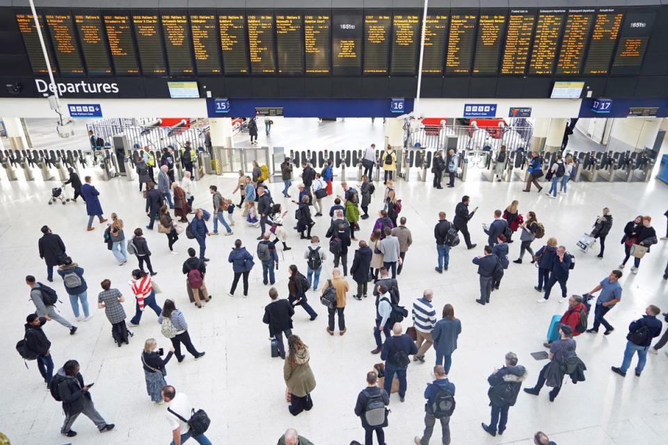 Passengers at London Waterloo station (PA Wire)