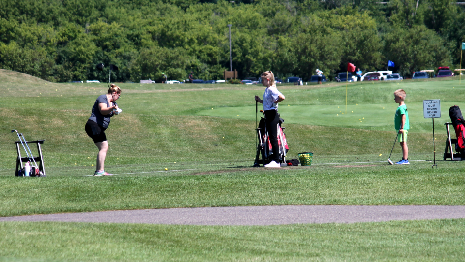 Golfers take swings at Fox Hills Golf and Banquet Center.