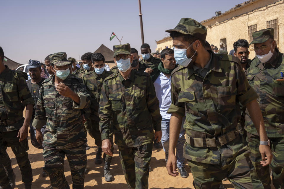 Brahim Ghali, head of the Polisario Front and the self-declared Sahrawi Democratic Arab Republic, center, attends a National Unity Day event in the Dajla refugee camp, Algeria, Tuesday, Oct. 12, 2021. (AP Photo/Bernat Armangue)