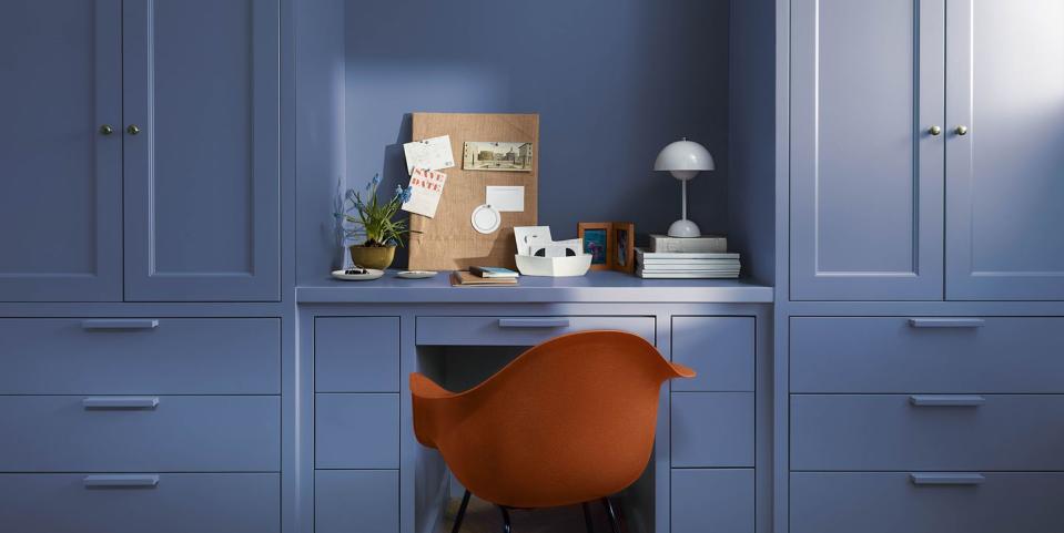 a chair in a room with white cabinets