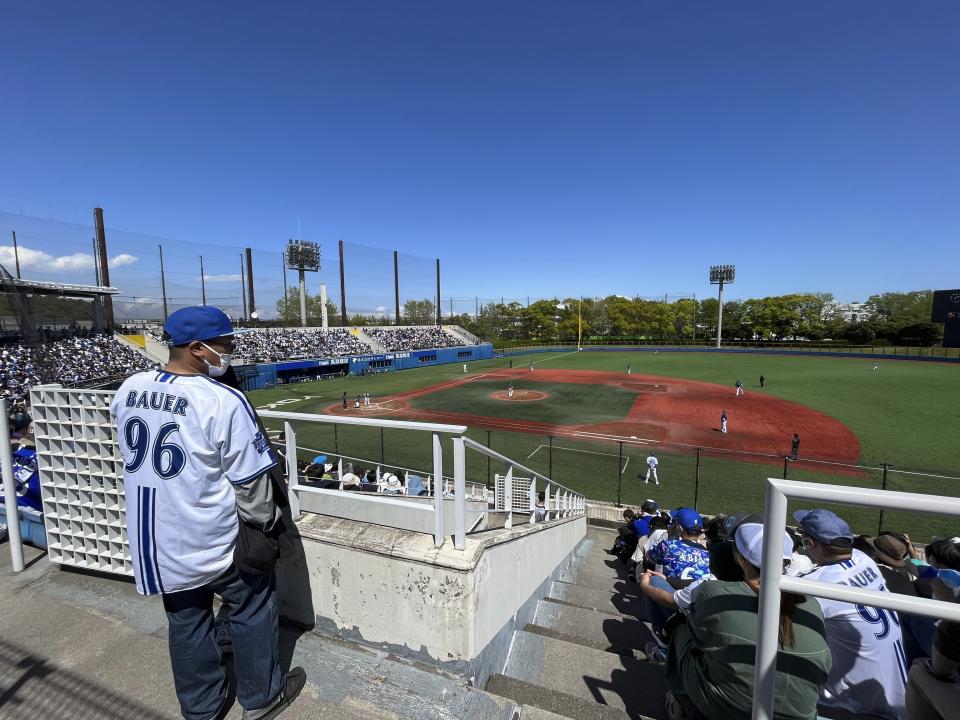 A fan wearing a shirt with the name of baseball player Trevor Bauer and his number, arrives at a stadium in Yokosuka, Japan, Sunday, April 16, 2023. Bauer pitched four innings Sunday for the Yokohama BayStars minor league team in Yokosuka as he prepares to pitch his first game for the Yokohama team. (AP Photo/Stephen Wade)