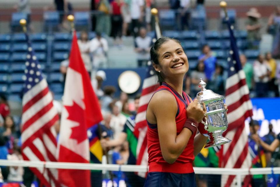 Emma Raducanu celebrates with the US Open trophy (AP)