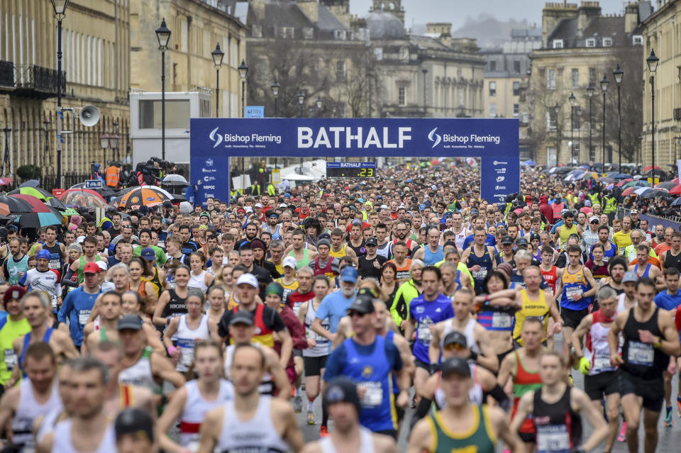 Runners at the start of the race during the Bath Half Marathon in Bath, England, Sunday, March 15, 2020. Despite coronavirus concerns, the half marathon has not been cancelled. For most people, the new coronavirus causes only mild or moderate symptoms. For some it can cause more severe illness, especially in older adults and people with existing health problems. (Ben Birchall/PA via AP)