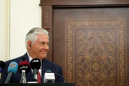 U.S. Secretary of State Rex Tillerson smiles alongside Qatar's Foreign Minister Sheikh Mohammed bin Abdulrahman Al Thani during a media availability after their meeting, in Doha, Qatar October 22, 2017. REUTERS/Alex Brandon/Pool