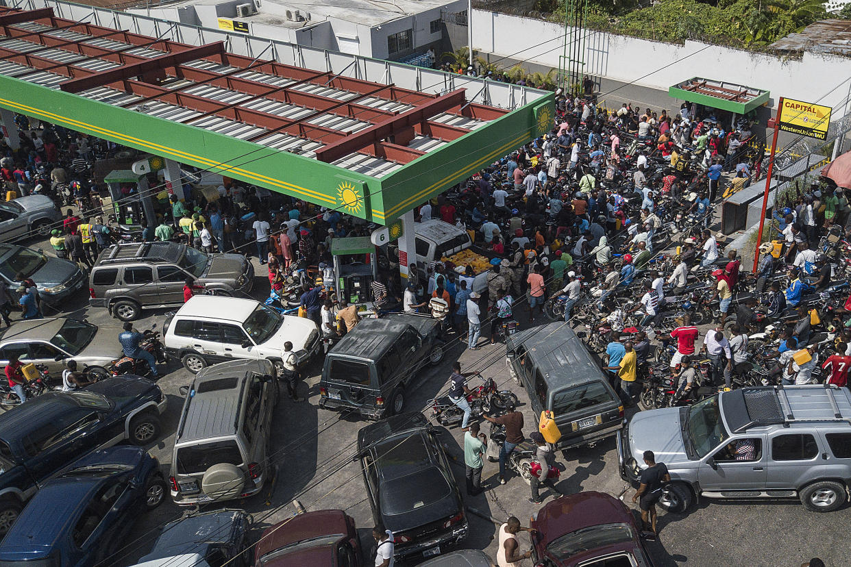 FILE - Drivers wait in hopes of filling their tanks at one of the few remaining open gas stations in Port-au-Prince, Haiti, Oct. 31, 2021. The U.S. government is urging U.S. citizens to leave Haiti given the country’s deepening insecurity and a severe lack of fuel that has affected hospitals, schools and banks. Gas stations remained closed on Thursday, Nov. 11, 2021, a day after the State Department issued its warning. (AP Photo/Matias Delacroix, File)