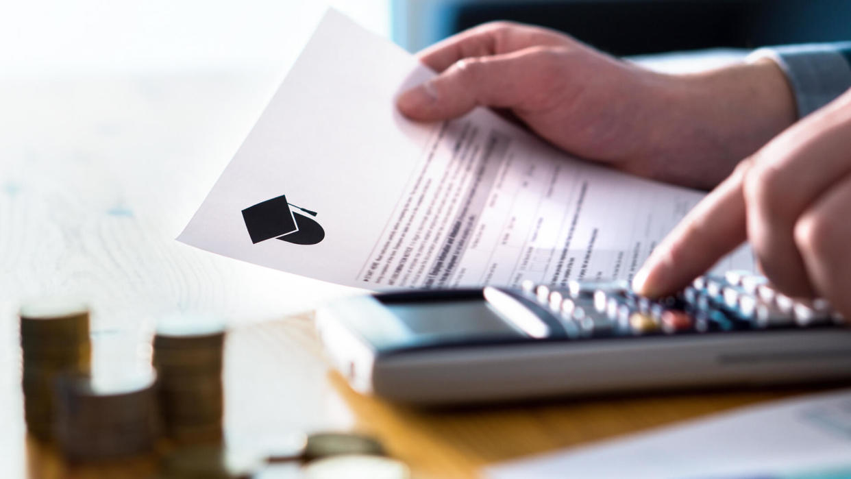 Man counting college savings fund, tuition fee or student loan with calculator.