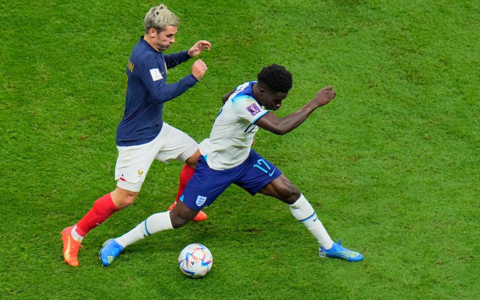 France's Antoine Griezmann, left, challenges for the ball with England's Bukayo Saka during the World Cup - ap