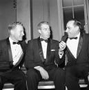 FILE - In this Jan. 29, 1961 file photo, Former New York Yankee Joe DiMaggio talks with former teammates Whitey Ford, left, and Yogi Berra, right, at 38th annual dinner of New York Chapter of the Baseball Writers' Association of America in New York. A family member tells The Associated Press on Friday, Oct. 9, 2020 that Ford died at his Long Island home Thursday night. (AP Photo/Marty Lederhandler)