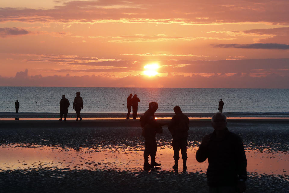 World War II reenactors gather at dawn on Omaha Beach, in Normandy, France, Thursday, June 6, 2019 during commemorations of the 75th anniversary of D-Day. (AP Photo/Thibault Camus)