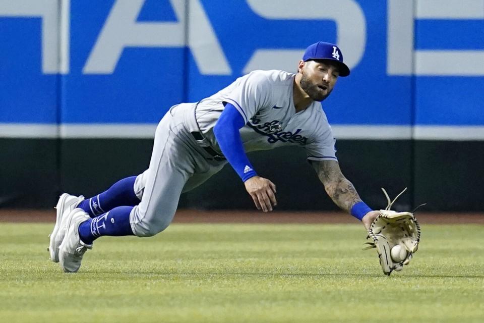 Dodgers left fielder Kevin Pillar makes a diving catch on a fly ball.