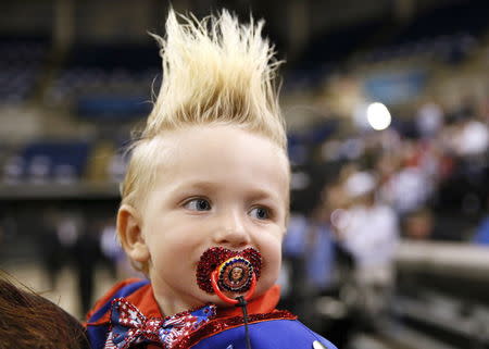 19-month-old Curtis Ray Jeffery II, of Louisiana, wears a pacifier with Trump's image on it before a rally in Baton Rouge. REUTERS/Jonathan Bachman