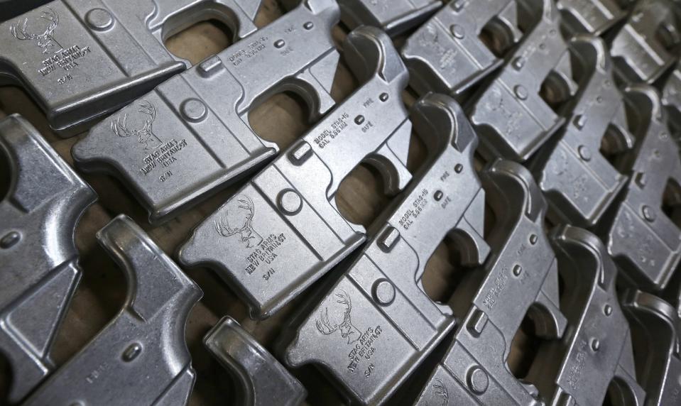 FILE - In this April 10, 2013, file photo a box of AR-15 rifle lower receivers awaiting serial number stamping and finishing at the Stag Arms company in New Britain, Conn. Two of the hottest trends in investing are working in tandem to steer billions of dollars toward companies seen as the best corporate citizens. The sustainable investing field in its early days attracted investors by avoiding so-called “sin stocks”-- gun makers, cigarette manufacturers, etc. (AP Photo/Charles Krupa, File)