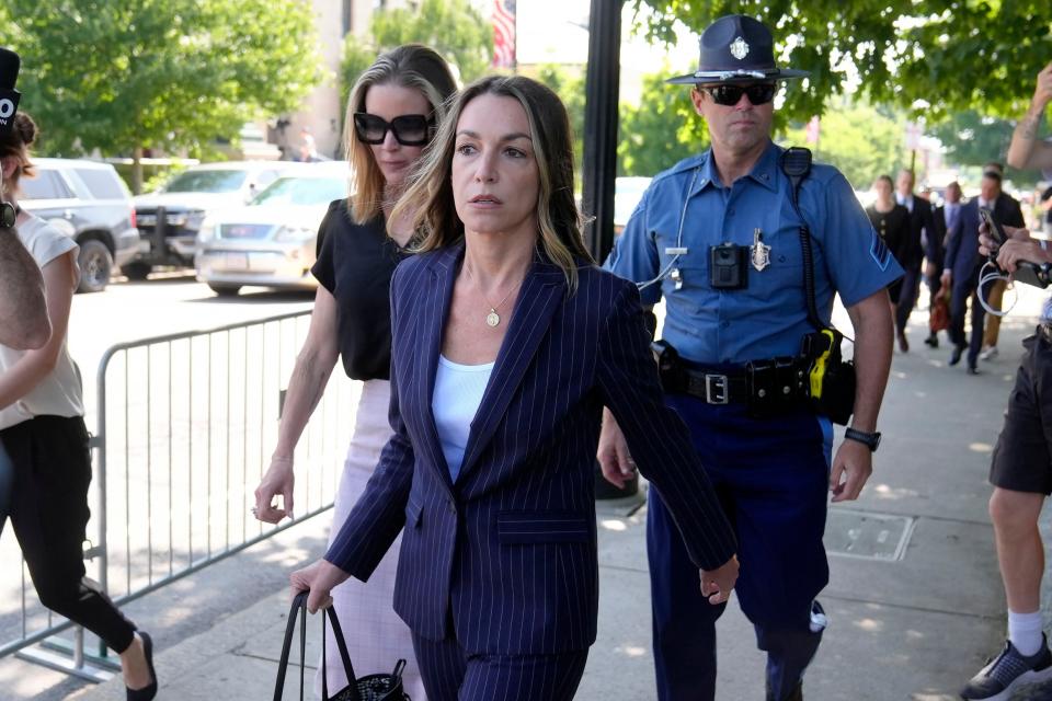 Karen Read, center, departs Norfolk Superior Court, Wednesday, June 26, 2024, in Dedham, Mass. Read is on trial, accused of killing her boyfriend Boston police Officer John O'Keefe, in 2022. The jury began deliberations in the trial Tuesday. (AP Photo/Steven Senne)