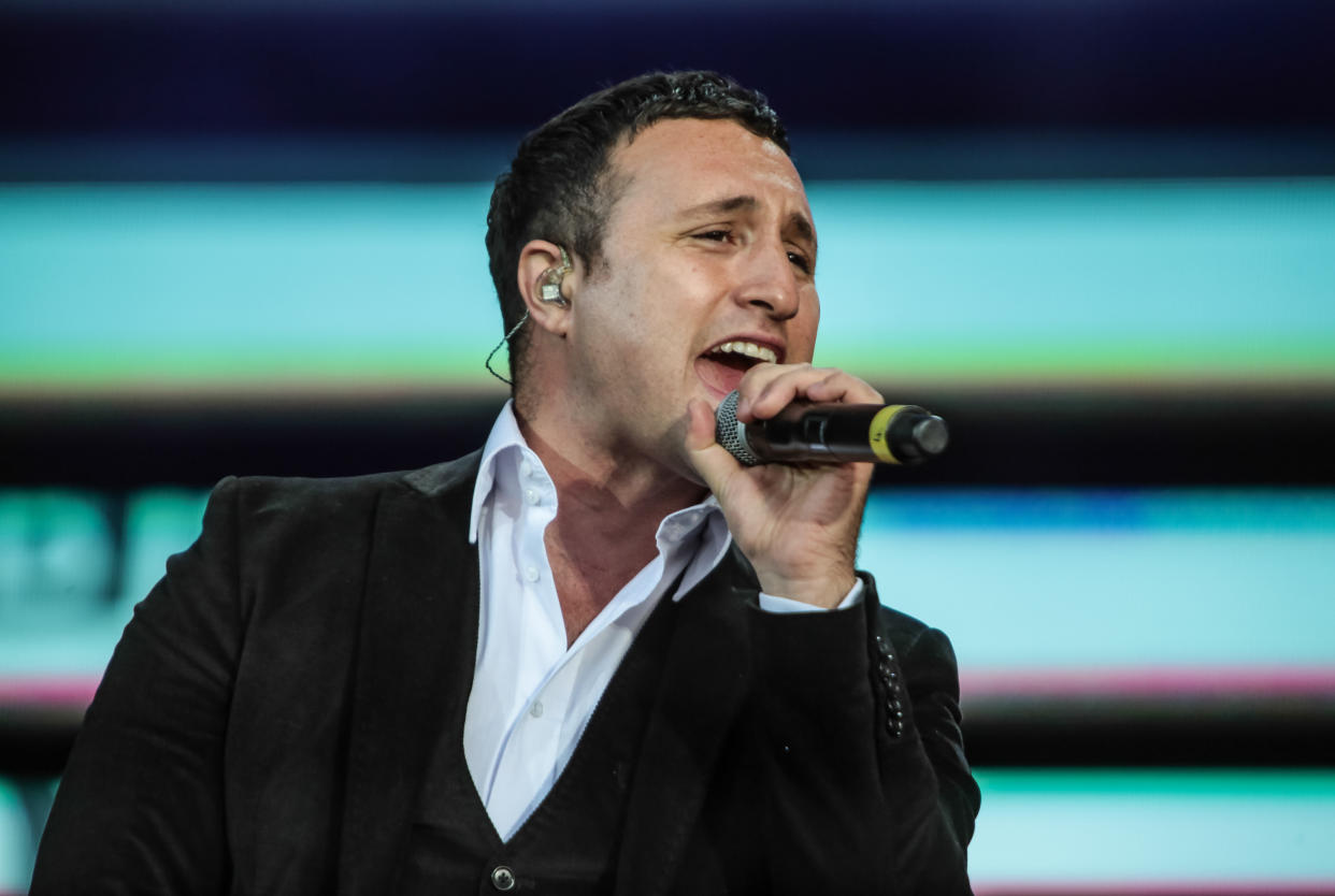 LONDON, UNITED KINGDOM - SEPTEMBER 07: Antony Costa of Blue performs on stage as part of BBC Proms In The Park at Hyde Park on September 7, 2013 in London, England. (Photo by Christie Goodwin/Redferns via Getty Images)