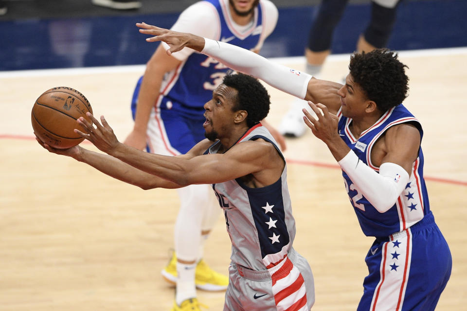 Washington Wizards guard Ish Smith, left, goes to the basket past Philadelphia 76ers guard Matisse Thybulle, right, during the first half of Game 3 in a first-round NBA basketball playoff series, Saturday, May 29, 2021, in Washington. (AP Photo/Nick Wass)