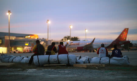 Members of The Indonesian Red Cross Society PMI (Palang Merah Indonesia) have a rest at Mutiara Sis Al-Jufri Airport in Palu, Central Sulawesi, Indonesia, October 7, 2018. REUTERS/Hannibal Hanschke