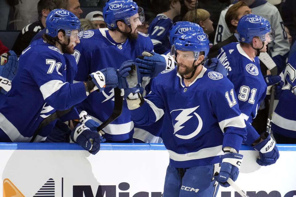 Tampa Bay Lightning center Luke Glendening (11) celebrates his goal against the New Jersey Devils with the bench during the first period of an NHL hockey game Thursday, Jan. 11, 2024, in Tampa, Fla. (AP Photo/Chris O'Meara)