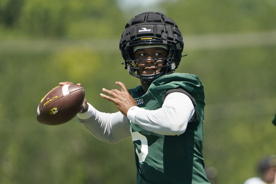 Missouri quarterback Tyler Macon throws during an NCAA college football practice Wednesday, Aug. 10, 2022, in Columbia, Mo. (AP Photo/Jeff Roberson)