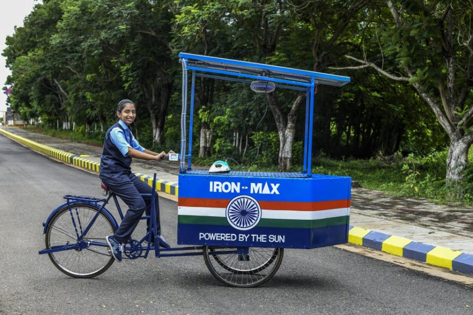 Vinisha Umashankar with the solar-powered ironing cart she designed (PA)