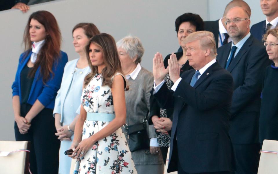 US President Donald Trump and US First Lady Melania Trump watch the annual Bastille Day military parade on the Champs-Elysees avenue in Paris - Credit: JOEL SAGET/AFP