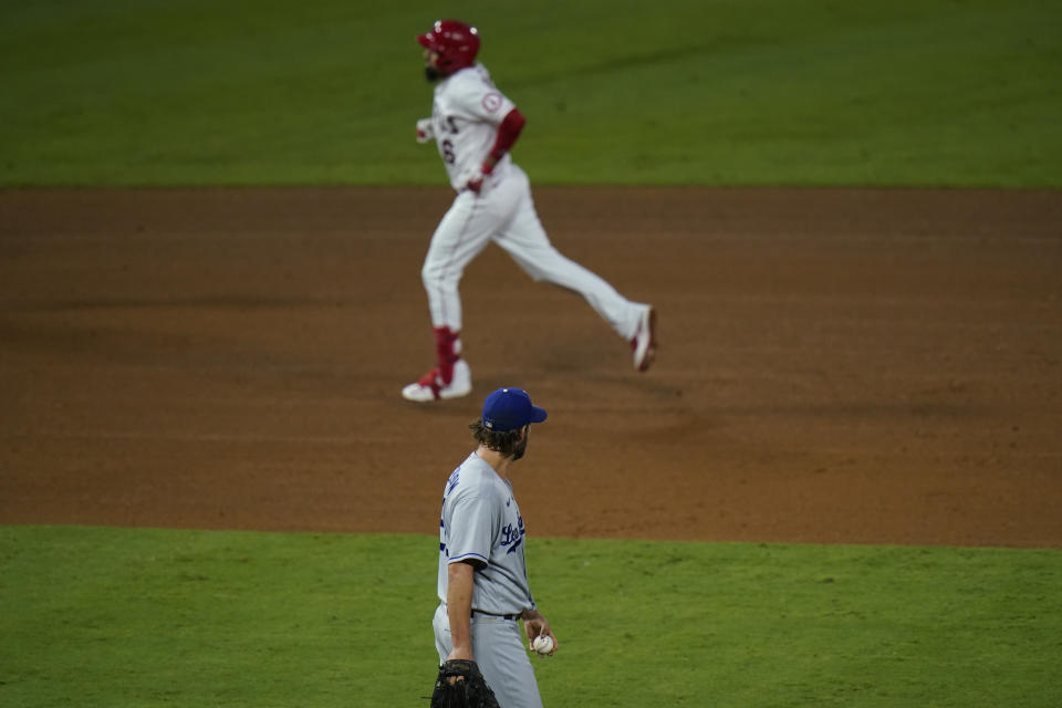 Los Angeles Dodgers starting pitcher Clayton Kershaw, bottom, stands near the mound after giving up a home run against Los Angeles Angels' Anthony Rendon during the fifth inning of a baseball game, Friday, Aug. 14, 2020, in Anaheim, Calif. (AP Photo/Jae C. Hong)