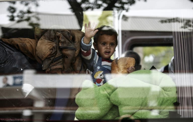A migrant child looks through a bus window while waiting to cross to Europe near Turkey's western border with Greece and Bulgaria, in Edirne on September, 23 2015