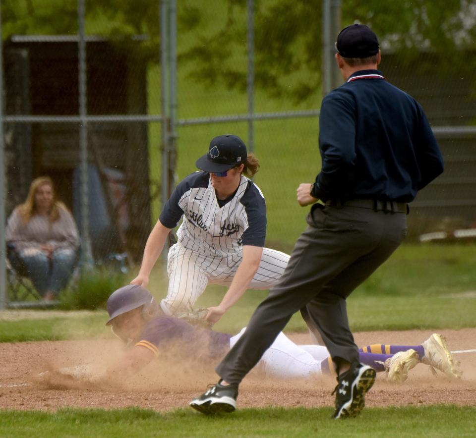 Granville third baseman Sawyer Benschoter tags out Bloom-Carroll's Ayden Anderson, completing a crucial 6th-inning double play during their Division II district semifinal Monday. The Blue Aces won 1-0.