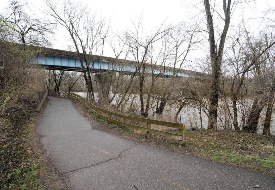Mar 31, 2023; Worthington, Ohio, United States; The bike path runs under the Wilson Bridge Road bridge that will be closed for three months during improvements. Mandatory Credit: Brooke LaValley/Columbus Dispatch