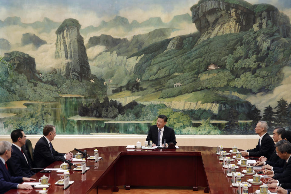 Chinese President Xi Jinping, center, speaks as U.S. Trade Representative Robert Lighthizer, third from left, U.S. Treasury Secretary Steven Mnuchin, second from left, Chinese Vice Premier Liu He, fourth from right, and delegations from both countries listen during a meeting at the Great Hall of the People in Beijing, Friday, Feb. 15, 2019. (AP Photo/Andy Wong, Pool)