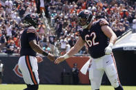 Chicago Bears quarterback Justin Fields, left, is congratulated by Adam Redmond (62) after throwing a touchdown pass against the Miami Dolphins during the second half of an NFL preseason football game in Chicago, Saturday, Aug. 14, 2021. (AP Photo/David Banks)