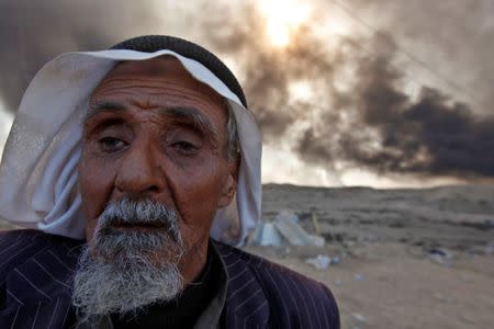 A man returns to his village after it was liberated from Islamic State militants, south of Mosul in Qayyara, Iraq, October 22, 2016. REUTERS/Alaa Al-Marjani