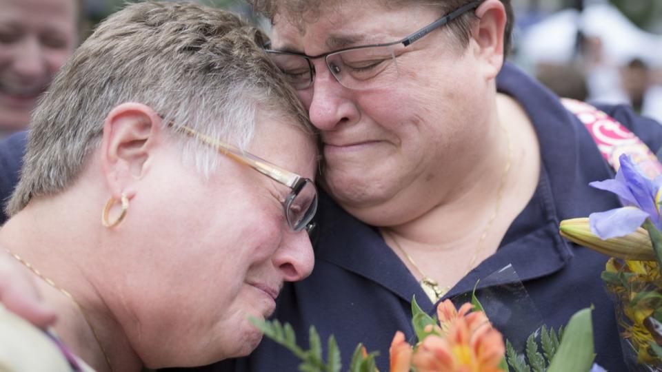 Barb Eisenhart, left, and Tiffany Wahl, hug before their marriage ceremony at Fountain Square, Friday, June 26, 2015, in Cincinnati, after the Supreme Court declared that same-sex couples have a right to marry anywhere in the United States.