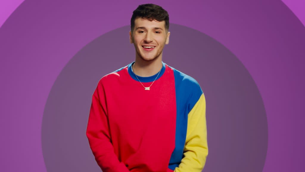 The Circle. Contestant Jordan Staff from episode 606 of The Circle, he's wearing a red, yellow, and blue shirt in front of a purple backdrsop