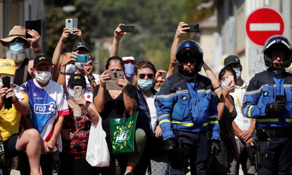 Spectators take pictures along the course during stage 16 from La Tour-du-Pin to Villard-de-Lans.