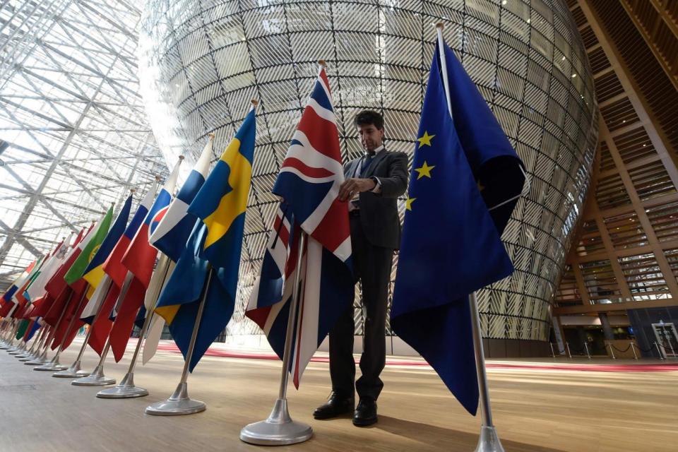 An organiser adjusts the British national flag prior to the summit (AFP/Getty Images)