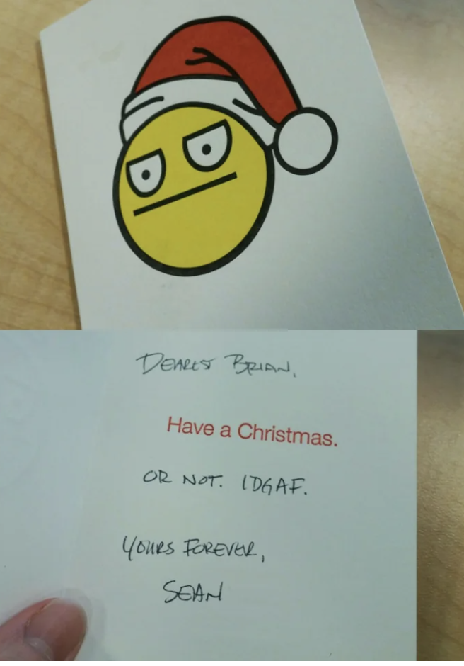 The front of the card has an unenthusiastic emoji wearing a Santa hat, and the inside of the card says "Have a Christmas, or not, I don't give a fuck"