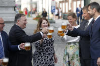 U.S. Secretary of State Mike Pompeo, second left, his wife Susan Pompeo, third left, Czech Republic's Foreign Minister Tomas Petricek, second right, and Petricek's wife Iva, third right, hold a glass of beer during a visit at a brewery in Pilsen near Prague, Czech Republic, Tuesday, Aug. 11, 2020. U.S. Secretary of State Mike Pompeo is in Czech Republic at the start of a four-nation tour of Europe. Slovenia, Austria and Poland are the other stations of the trip. (AP Photo/Petr David Josek, Pool)