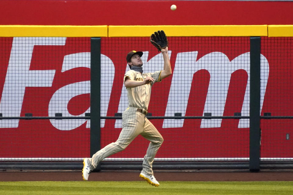 San Diego Padres right fielder Wil Myersmakes the running catch on a ball hit by Arizona Diamondbacks' Kole Calhoun in the first inning during a baseball game, Friday, Aug 14, 2020, in Phoenix. (AP Photo/Rick Scuteri)