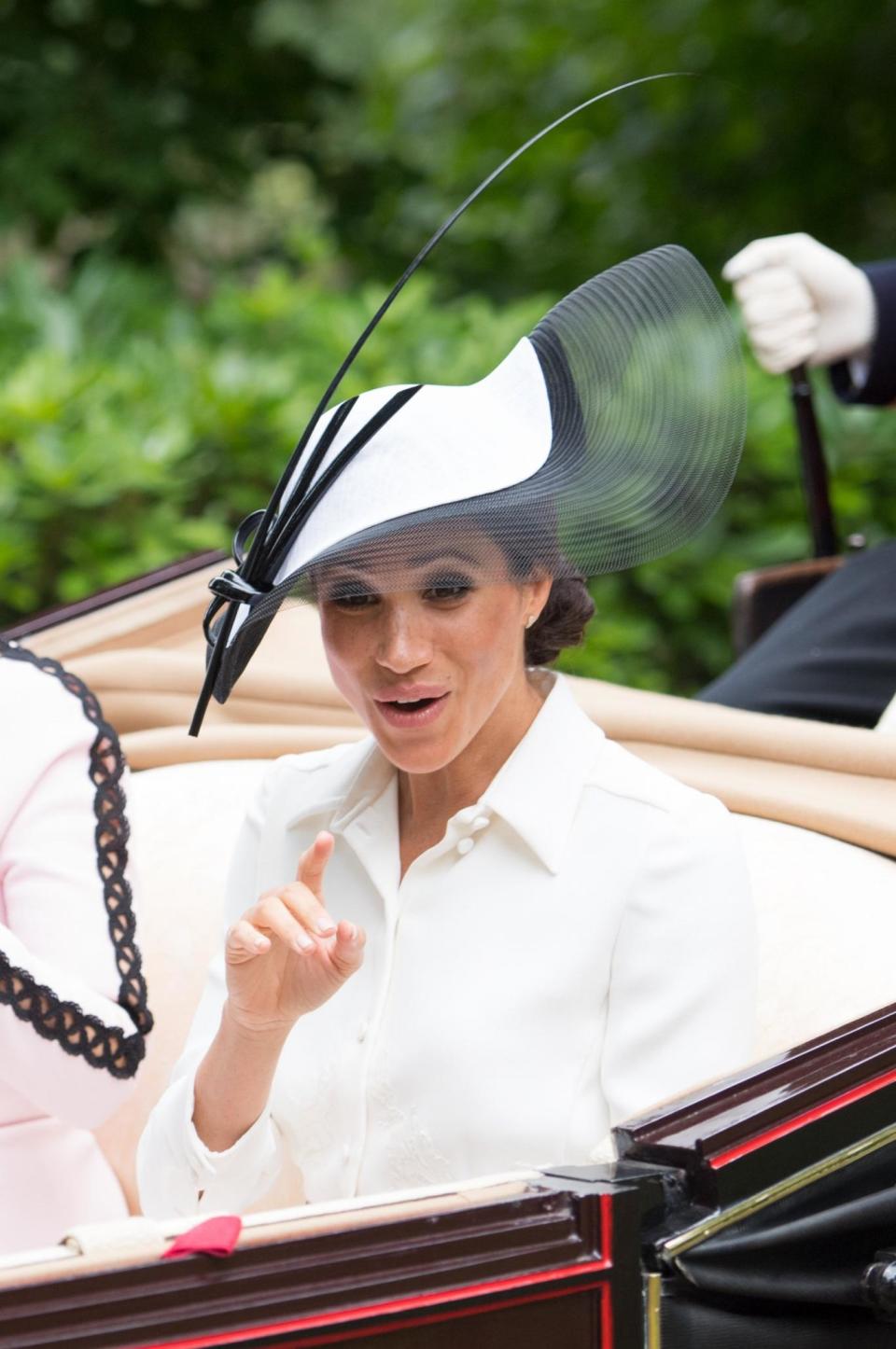 A delighted Meghan Markle points out to the crowd on her first visit to Royal Ascot with husband Prince Harry (SplashNews.com)