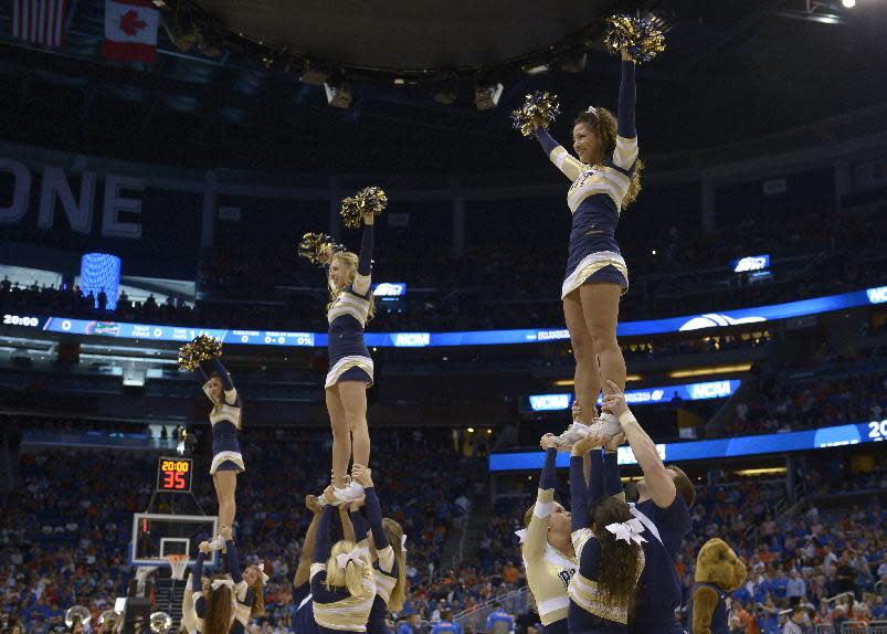 The Pittsburgh cheerleaders perform during the first half in a third-round game in the NCAA college basketball tournament against Florida, Saturday, March 22, 2014, in Orlando, Fla. (AP Photo/Phelan M. Ebenhack)