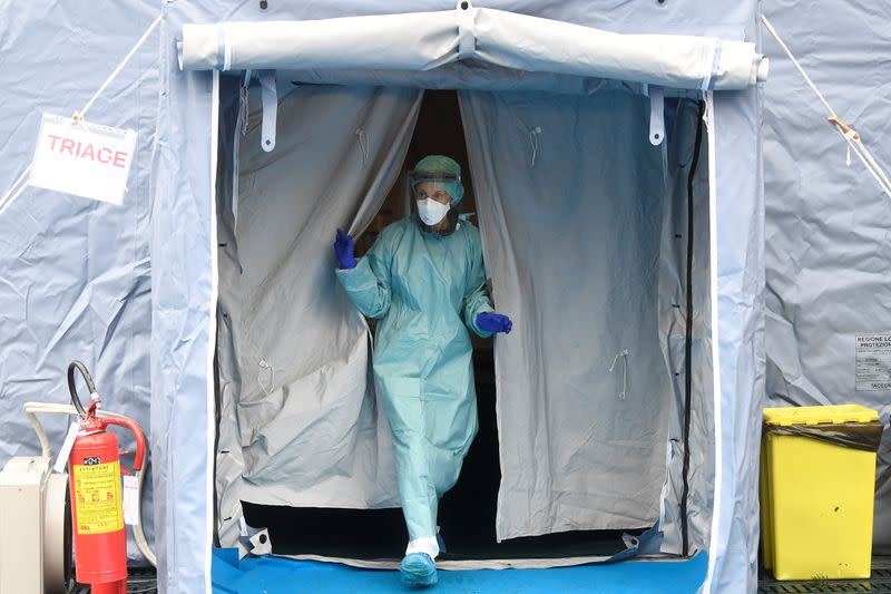 A medical worker wearing protective mask is seen at a medical checkpoint at the entrance of the Spedali Civili hospital in Brescia