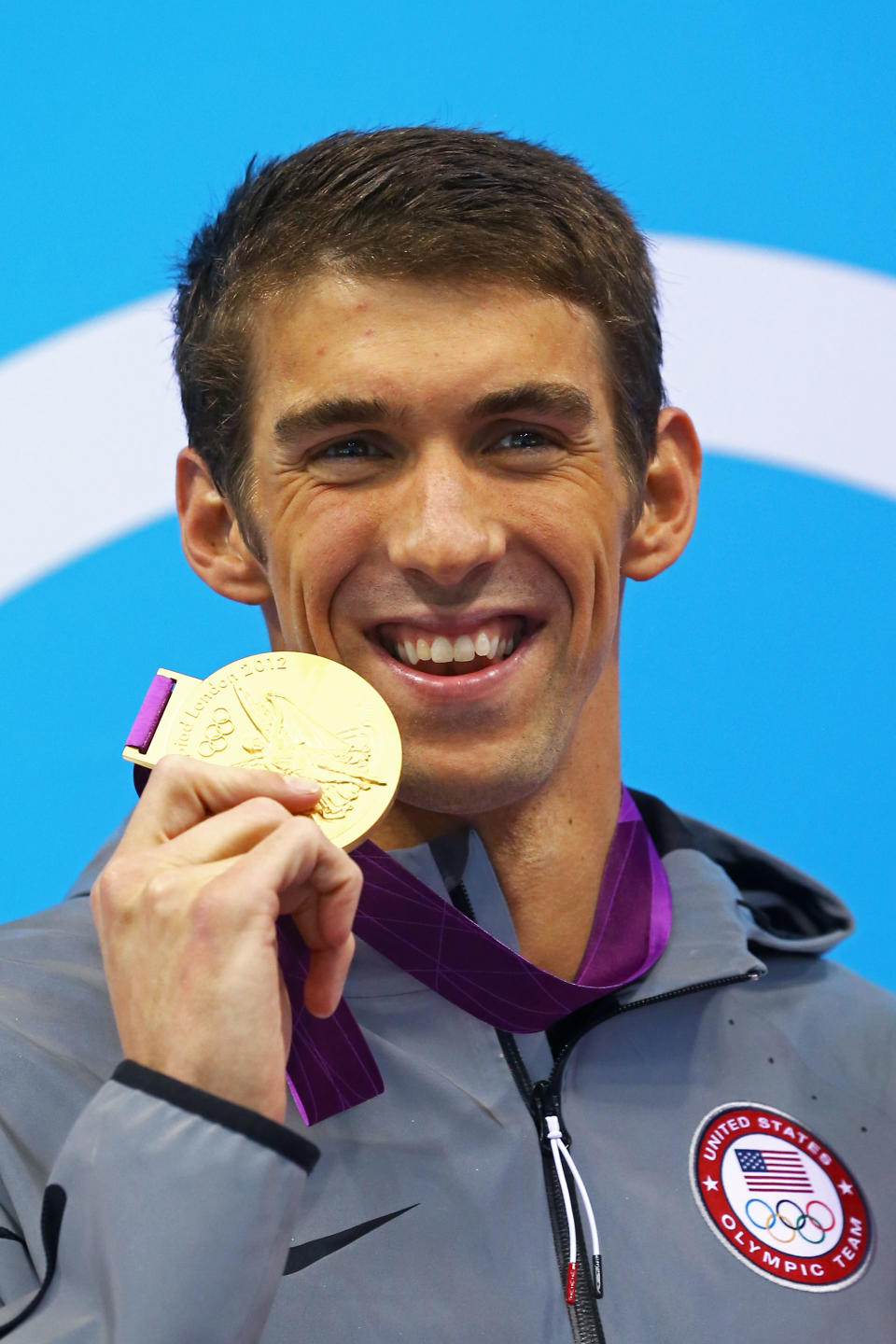 <b>Medal No. 21: </b>Gold medallist Michael Phelps of the United States poses on the podium during the medal ceremony for the Men's 100m Butterfly Final on Day 7 of the London 2012 Olympic Games at the Aquatics Centre on August 3, 2012 in London, England. (Photo by Al Bello/Getty Images)