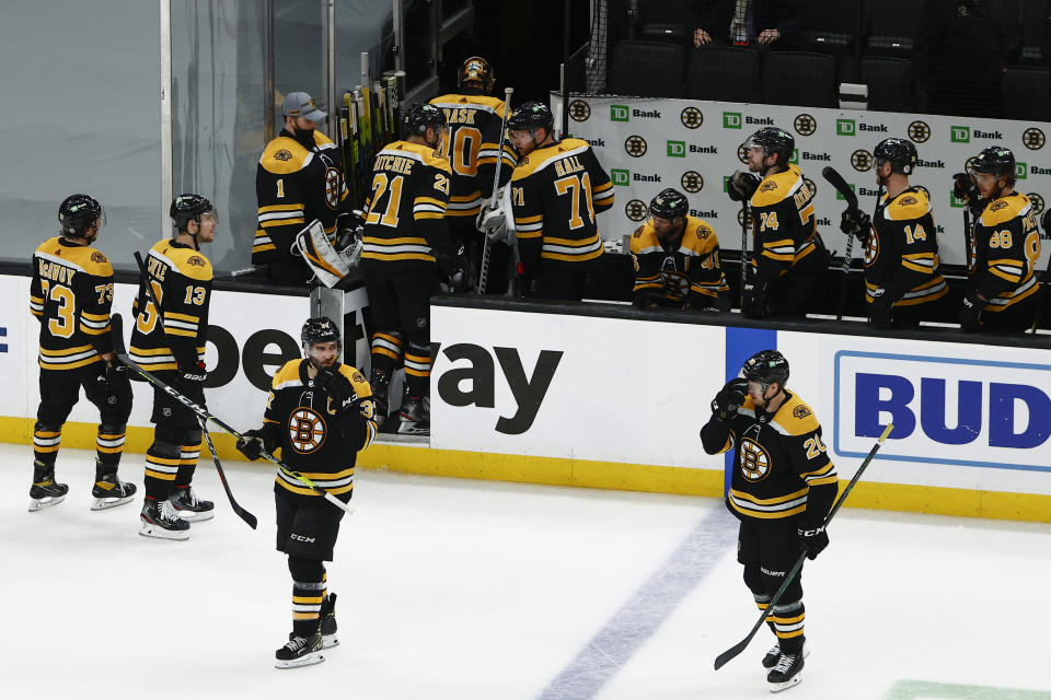 Boston Bruins' Patrice Bergeron, third from left, looks back as teammates head for the locker room after their loss to the New York Islanders in overtime of Game 2 of an NHL hockey second-round playoff series, Monday, May 31, 2021, in Boston. (AP Photo/Winslow Townson)