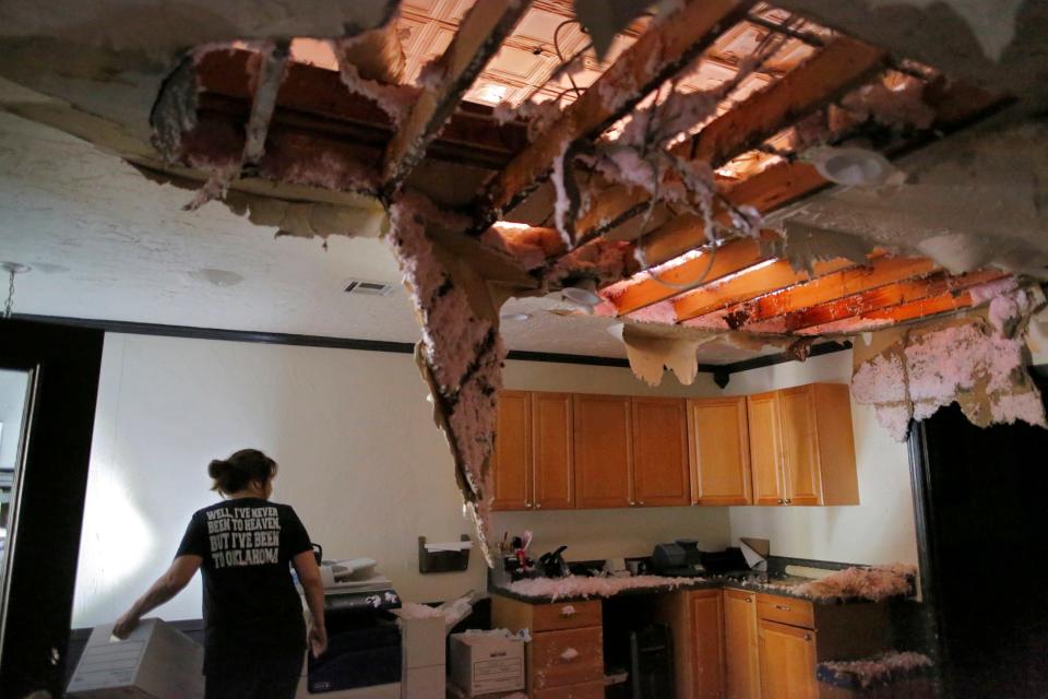 LeAnn Morgan cleans up tornado damage in Seminole on Thursday.
